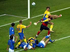 Sweden's Zlatan Ibrahimovic flicks the ball over Italian goalkeeper Gianluigi Buffon