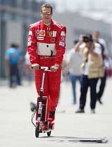 German Ferrari driver Michael Schumacher rides a motor scooter 