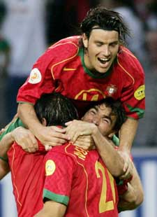 Portugal's Nuno Gomes is congratulated by team-mates Deco and Nuno Valente after scoring against Spain 