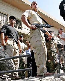 Iraqi security officers secure the site after an explosion near Iraq's central bank in Baghdad on Sunday