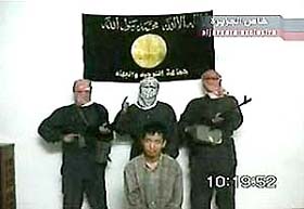 Masked men stand around a South Korean hostage in a videotape aired on Arabic television station Al-Jazeera 
