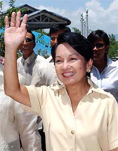 Philippine President Gloria Macapagal Arroyo waves to supporters during her visit to Vigan town in northern Philippines on Monday