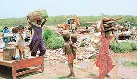 Jhuggi-dwellers remove their belongings during an anti-encroachment drive in Sector 21 in Panchkula