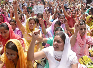 Members of the Unemployed Elementary Teachers Union from all over Punjab stage a dharna in protest against the recruitment of teachers on a contract basis at Matka Chowk in Chandigarh on Tuesday. 