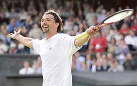 Goran Ivanisevic of Croatia celebrates his victory over 31st seed Mikhail Youzhny of Russia in their first round match at Wimbledon