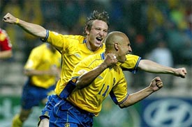 Sweden Kim Kallstrom runs behind Henrik Larsson as they celebrate scoring a goal from the penalty spot against Denmark during their group C match
