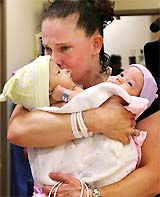 Melissa Buckles, of Woodbridge, Va, weeps as she prepares to hand off her conjoined twin daughters Jade and Erin Buckles for their surgery at Children�s National Medical Center in Washington