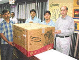 Mr Puneet Jawa is presented with an LG 1.5 air-conditioner by officials of Grasim Suiting