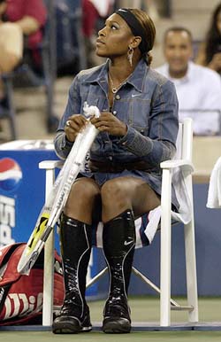 Serena Williams of the US wears knee-high boots prior to her match against Sandra Kleinova of the Czech Republic at the US Open in New York on Monday