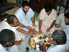 Seven captive truck drivers having dinner the night before their release in Baghdad