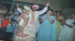 Gurjit Singh dances with his wife after their marriage on July 3, 2004. The photo has been copied from their marriage album.