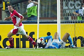 England goalkeeper David James lies on the ground as Austria's Mario Haas celebrates a goal during a World Cup qualifying match