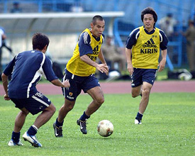 Japanese soccer players Takahara Naohiro and Endo Yasuhito practise during a training session in Kolkata 