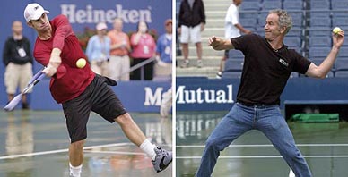 US player Andy Roddick hits balls pitched by tennis legend John McEnroe during a rain delay at the US Open