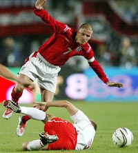 England�s David Beckham is tackled by Poland�s Tomasz Rzasa 