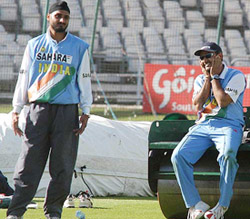 Virender Sehwag and Harbhajan Singh share a joke during net practice
