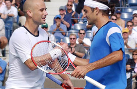 Andre Agassi shakes hands with Roger Federer after losing at the US Open