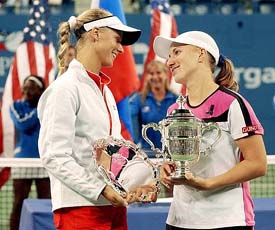 Svetlana Kuznetsova of Russia and compatriot Elena Dementieva pose with their US Open women's singles trophies in New York 