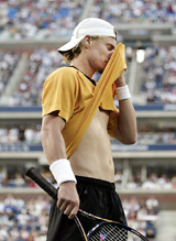 Lleyton Hewitt wipes his face during the third set of his loss to Roger Federer during the final of the US Open