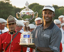 Vijay Singh holds up the trophy after winning the Bell Canadian Open on Sunday in Ontario. Singh won after defeating Mike Weir on the third play-off hole