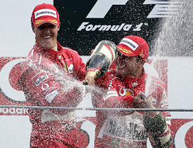 Ferrari's Brazilian rider Rubens Barrichello, winner of the F1 Italian Grand Prix, sprays champagne alongside teammate Michael Schumacher of Germany