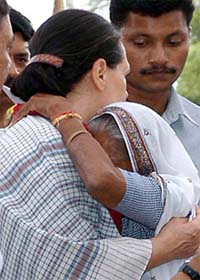 Congress President Sonia Gandhi hugs an old woman in her constituency at Sudhauli block in Rae Bareli