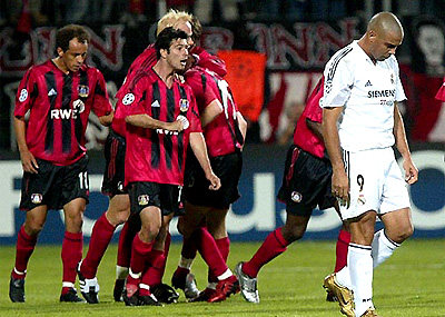 Real Madrid's Ronaldo looks dejected as Bayer Leverkusen's players celebrate a goal during their UEFA Champions League group B soccer match
