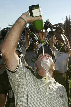European golfer Thomas Levet from France pours champagne into his mouth