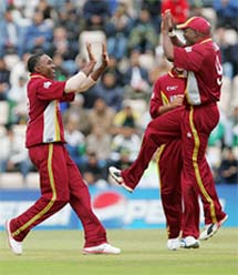 West Indies bowler Dwayne Bravo celebrates with Brian Lara after the dismissal of Pakistan�s Shoaib Malik during their ICC Champions Trophy semifinal at the Rose Bowl, Southampton