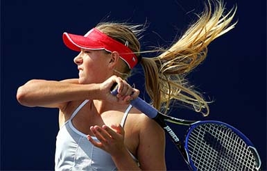 Russia's Wimbledon champion Maria Sharapova returns a backhand against Russia's Tatiana Panova