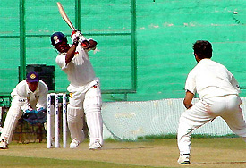 Mumbai all-rounder Ramesh Powar lofts a Murali Karthik delivery on the second day of the Irani Trophy final match between Mumbai and the Rest of India 