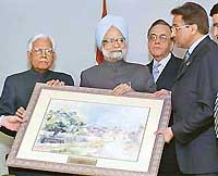 Prime Minister Manmohan Singh receives a painting presented to him by Pakistan President Pervez Musharraf