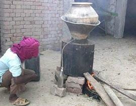 A labourer works at a still for producing illicit liquor at a village near Subhanpur of Kapurthala subdivision on Saturday.