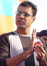 Former Pakistan captain and fast bowler Waqar Younis gives tips to young members of Karma, an NGO, at National Stadium in New Delhi on Saturday. 