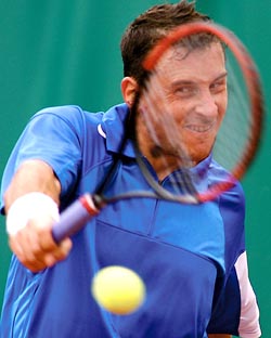 Andrei Pavel of Romania returns a backhand to Frank Dancevic of Canada during their Davis Cup World Group playoff tennis match in Bucharest