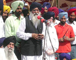 SAD President Parkash Singh Badal addresses party supporters at a dharna in front of the district administration office in Kapurthala on Monday. 