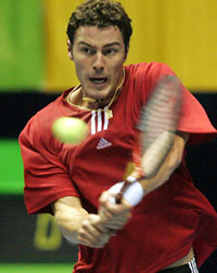 Marat Safin of Russia returns a backhand to Noam Okun of Israel during their match at the Thailand Open in Bangkok on Wednesday