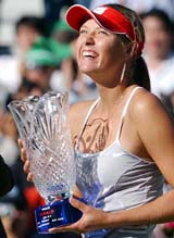 Wimbledon champion Maria Sharapova of Russia smiles as she holds the winner's trophy after winning the Korea Open