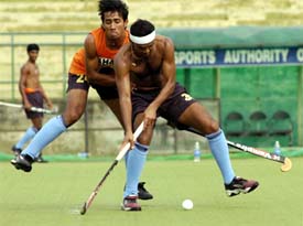 Indian players practice at the National Stadium in New Delhi