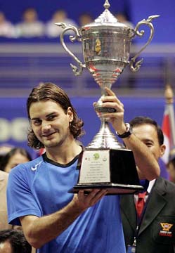 Roger Federer of Switzerland lifts the King�s Cup after his victory over Andy Roddick of the USA in the Thailand Open