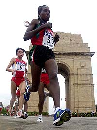 Runner-up Lydia Cheromei of Kenya and gold medallist Sun Ying Jie of China run past India Gate 