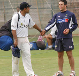 Virender Sehwag chats with Australian player Brad Hodge during a practice session in Bangalore