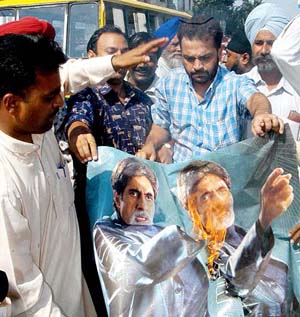 Activists of the Punjab Pradesh Youth Congress, led by its secretary, Mr Narinder Kumar Teenu, burn posters of Amitabh Bachchan in Amritsar on Tuesday in protest against the alleged irresponsible remarks against the Gandhi family by Ms Jaya Bachchan at an election rally. 
