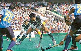 Pakistan’s star player Sohail Abbas tries to clear the ball past the bunch of Indian players during the hockey Dosti Series-2004 at the Sector 42 Hockey Stadium in Chandigarh on Wednesday.