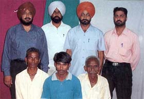 Murari Lal sits along with his father Ram Chander and uncle after they were reunited by the Bathinda police