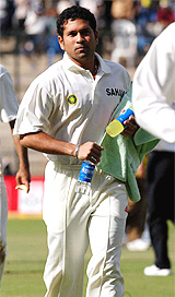 Master blaster Sachin Tendulkar carries refreshment for his teammates during a drinks break on the opening day of the first Test match between India and Australia 