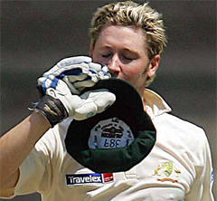 Australia's Michael Clarke kisses his cap after completing his maiden century