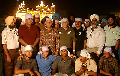 Indian and Pakistani hockey players and officials pose outside the Golden Temple 
