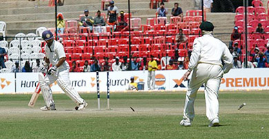 Parthiv Patel looks back at his stumps after being bowled by Jason Gillespie on the third day of the first Test between India and Australia at Bangalore