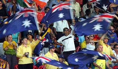 Australian cricket fans wave their national flag during the third day's play of the first Test between India and Australia in Bangalore on Friday
